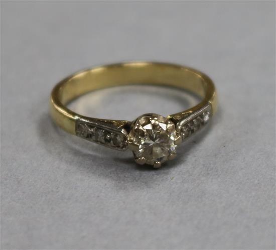 A diamond solitaire ring (approx 0.4ct), with diamond-set shoulders and yellow gold shank, size M.